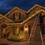 last minute christmas light installation house at night